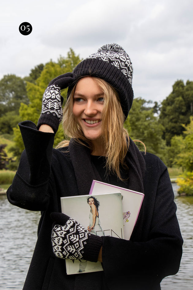 woman wearing black fair isle knitted gloves and hat