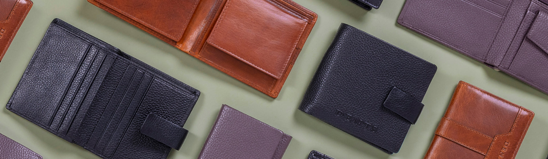 Collection of various leather wallets on a light green background