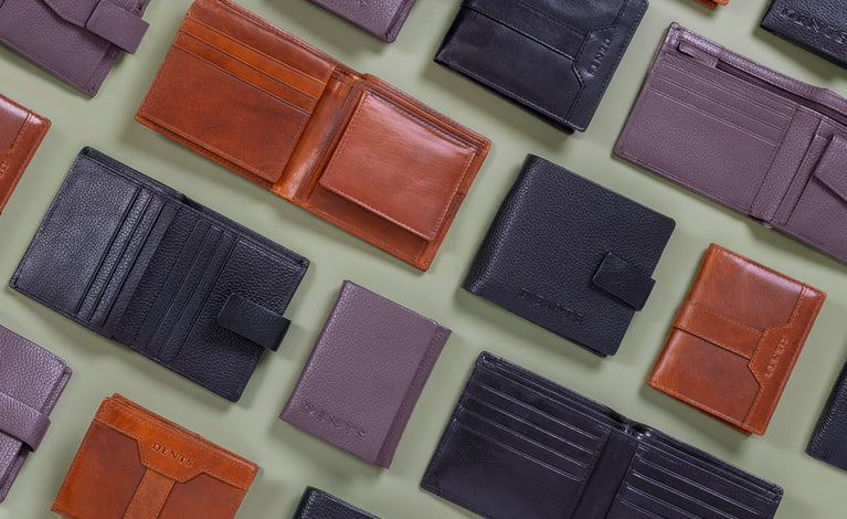 Collection of various leather wallets on a light green background
