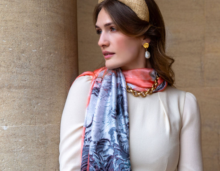 Woman wearing summer scarf in coral at a state house