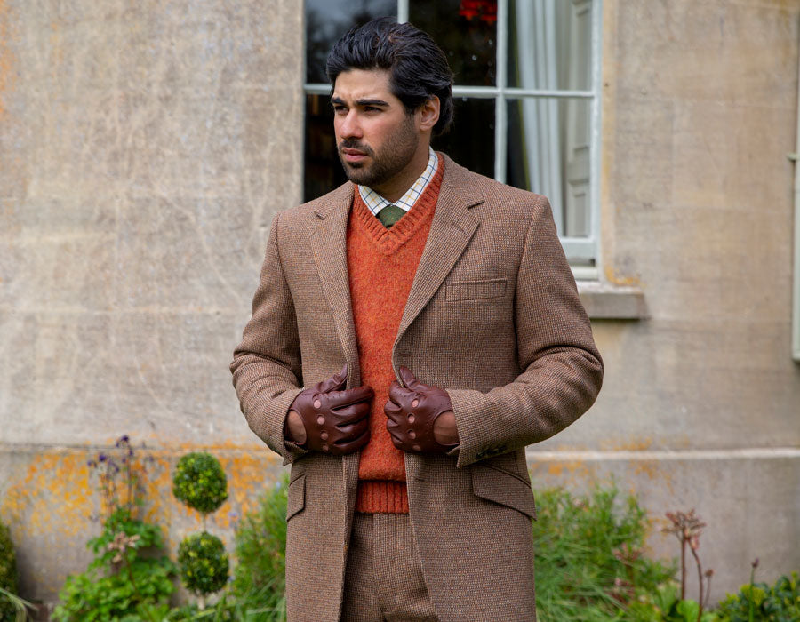 Man wearing leather driving gloves in brown outdoors