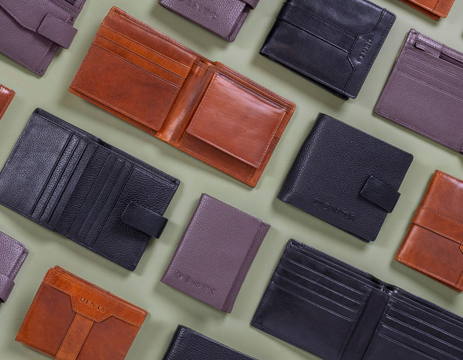 Collection of various leather wallets in different colors on a light green background