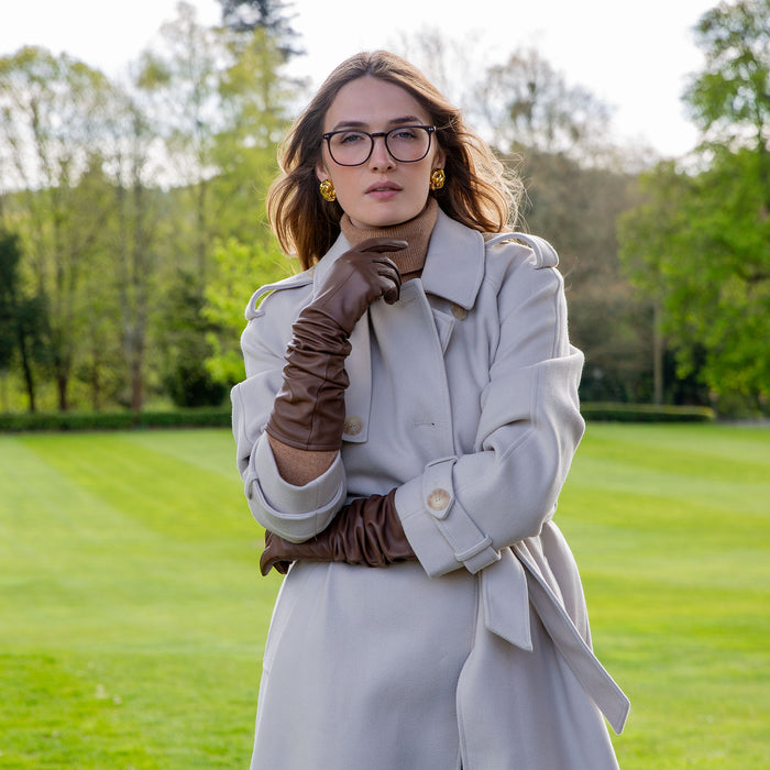 Woman wearing country brown single point long above elbow lined leather gloves
