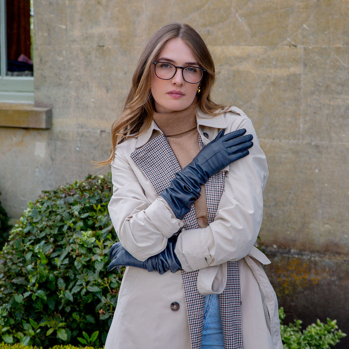 Woman wearing long leather gloves in navy scrunched down