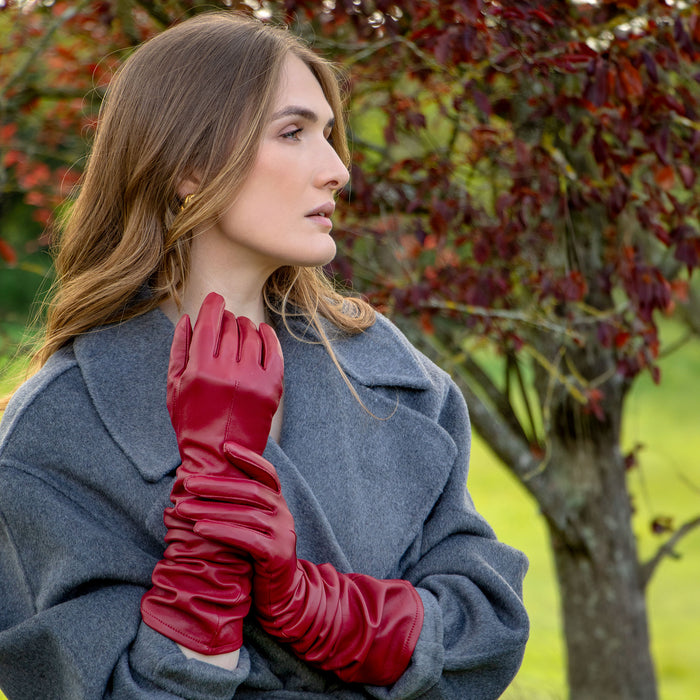 Woman wearing long leather gloves in wine scrunched down