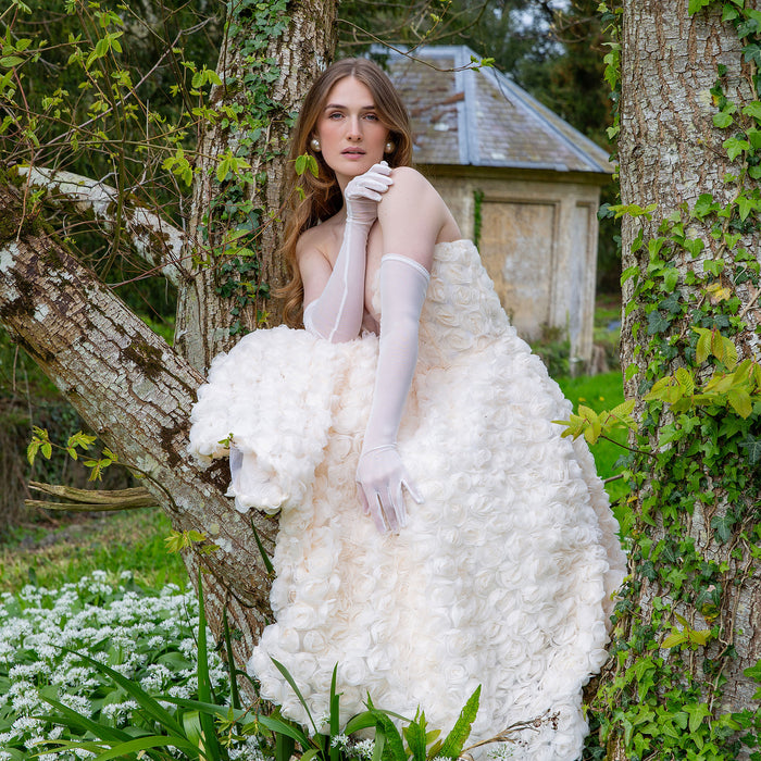 Woman wearing long tulle gloves in ivory